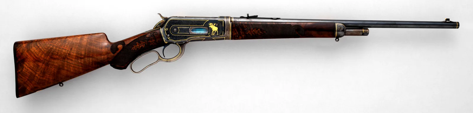Winchester Model 1886 takedown rifle made in 1901, left side, with engraved receiver.