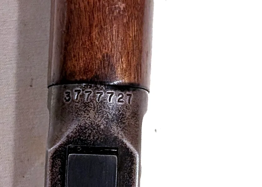 Close-up of a Winchester Model 94 receiver underside with the serial number 3777727 stamped ahead of the lever.