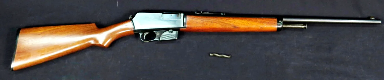 Winchester Model 1905 self-loading rifle, left side, on a dark cloth.