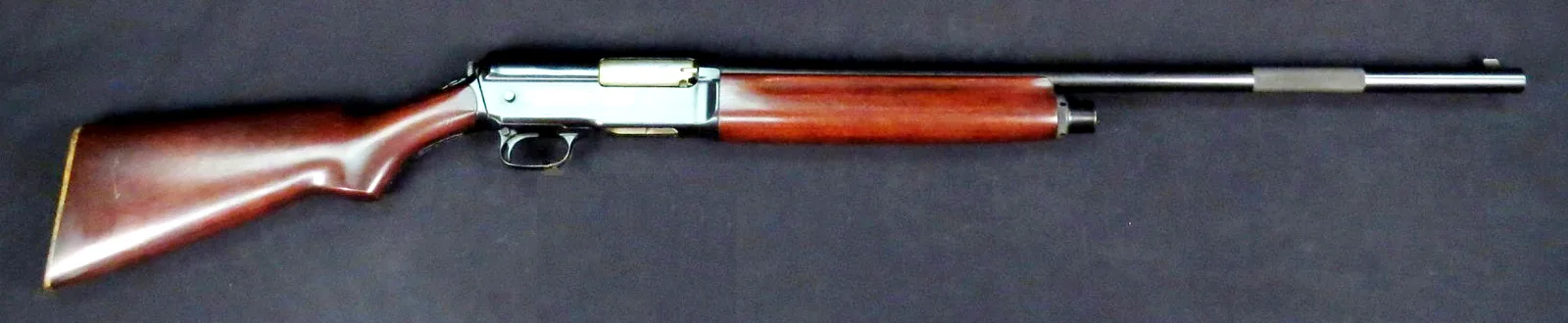 Winchester Model 1911 SL self-loading shotgun, left side, on a dark cloth.