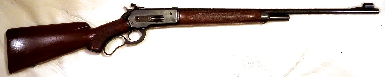 Winchester Model 71 lever-action rifle, left side, on a light background.
