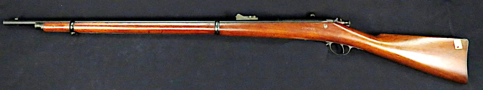 Winchester-Hotchkiss second model bolt-action rifle, right side, on a dark cloth.